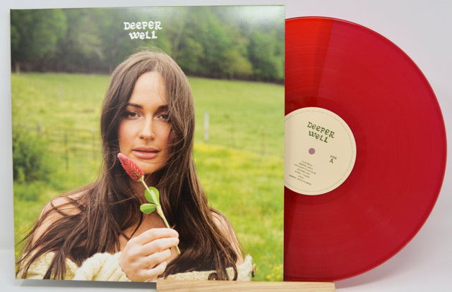 Deeper Well album cover with woman holding a red flower, alongside the limited edition red vinyl record