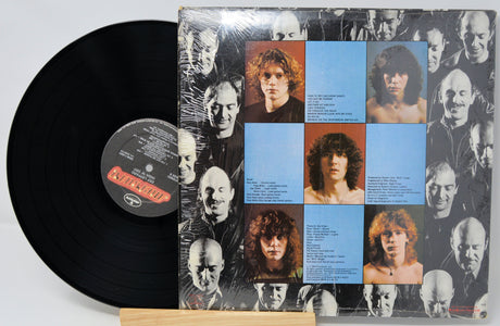 Vinyl record with a cover featuring multiple faces and text on a white background