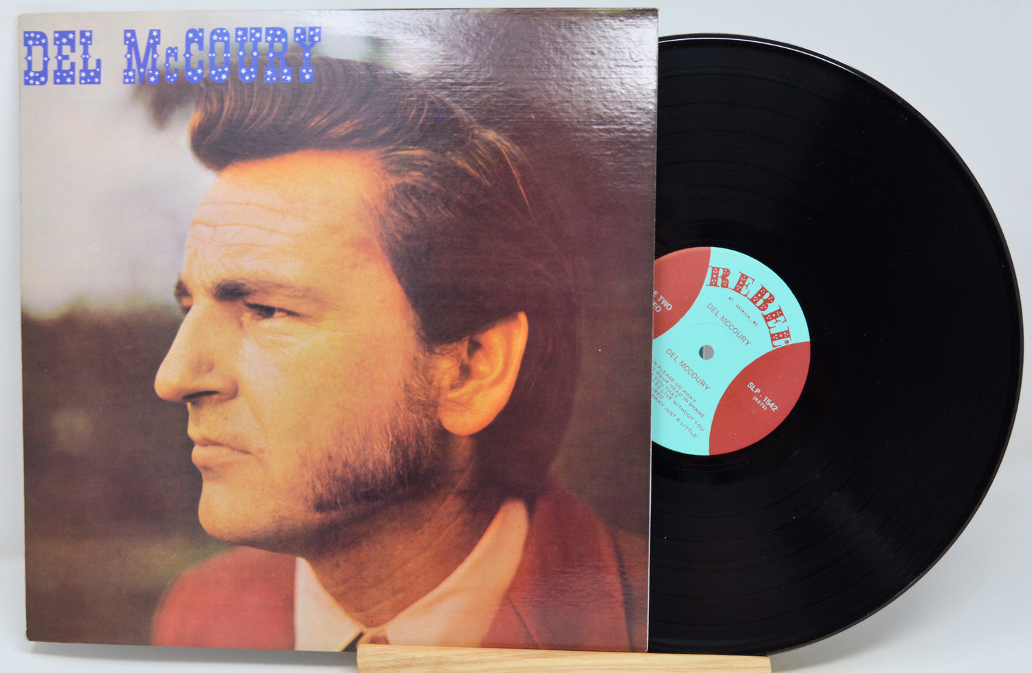 Del McCoury vinyl record album with the cover partially pulled from the black record, photographed on a light background.