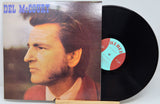 Del McCoury vinyl record album with the cover partially pulled from the black record, photographed on a light background.
