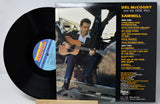 Del McCoury and the Dixie Pals 'Sawmill' vinyl record with the black LP partially visible behind the album cover, photographed on a light neutral background.