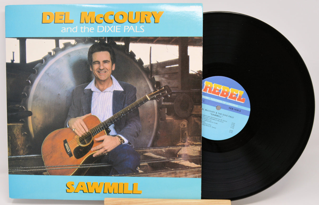Del McCoury and the Dixie Pals 'Sawmill' vinyl record album with the jacket cover and black LP record partially visible on a light background.