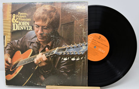 Vinyl record with cover featuring John Denver playing guitar, on a white background