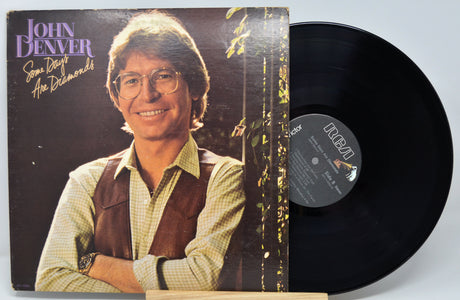 Vinyl record with John Denver album cover showing the artist and album name.