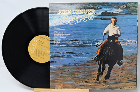 Vinyl record with a cover featuring a person riding a horse on a beach.