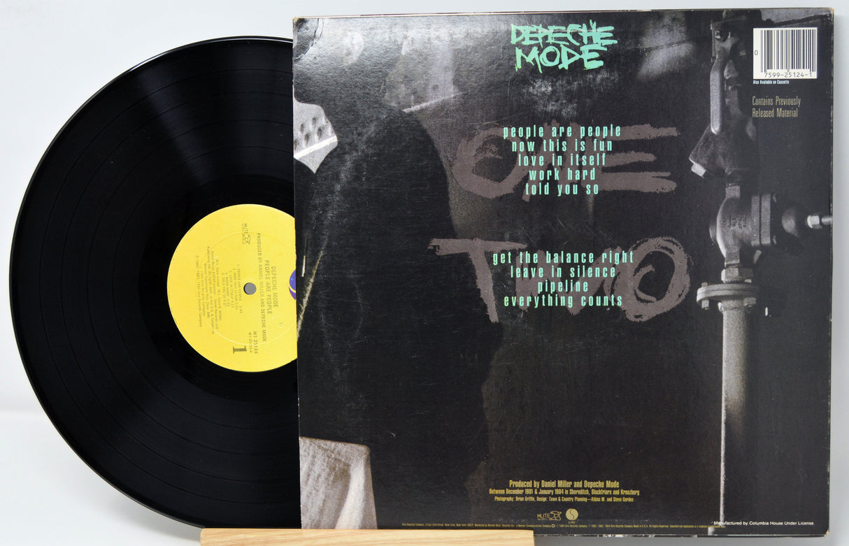 Vinyl record with cover featuring Depeche Mode on a white background