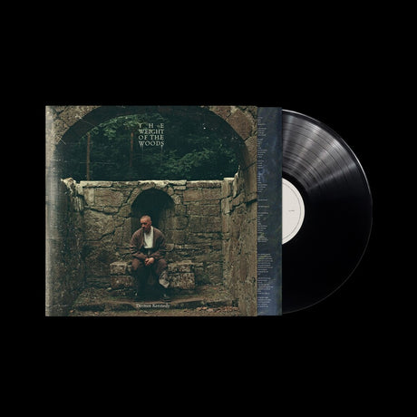 Vinyl record with a cover featuring a person sitting in a stone archway.
