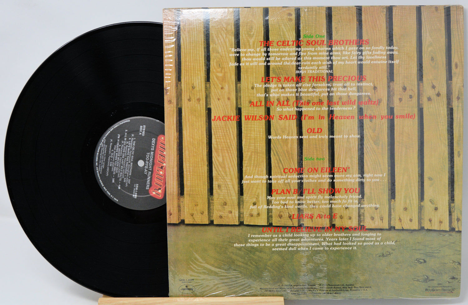 Vinyl record with a wooden sleeve featuring text