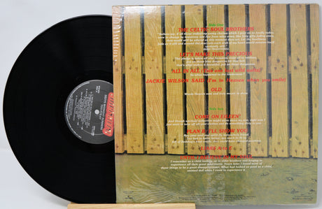 Vinyl record with a wooden sleeve featuring text