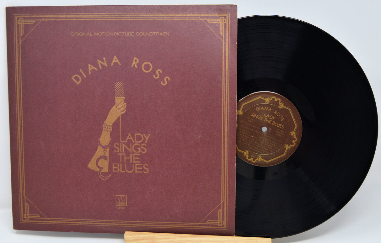 Vinyl record with maroon cover featuring 'Diana Ross' and 'Lady Sings the Blues'.
