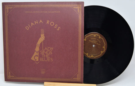 Vinyl record with maroon cover featuring 'Diana Ross' and 'Lady Sings the Blues'.