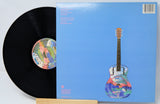 Vinyl record with a colorful guitar illustration on the cover