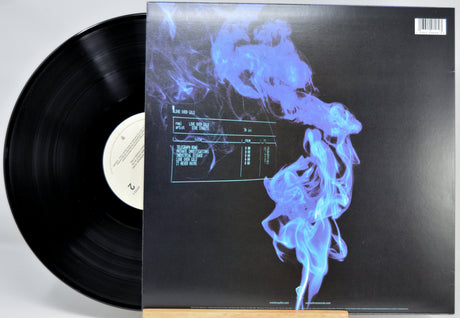 Vinyl record album shown with the black LP partially pulled from the sleeve, which features a dark cover with a glowing blue smoke-like graphic and tracklist text.