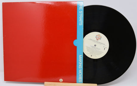 Vinyl record with red cover and black disc on a white background