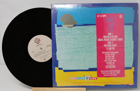 Vinyl record with colorful cover featuring text and graphics on a white background