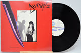 Vinyl record with a red cover featuring a black and white photo of a woman and the word 'Divinyls'.