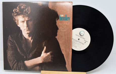 Vinyl record with cover featuring a person, on a white background