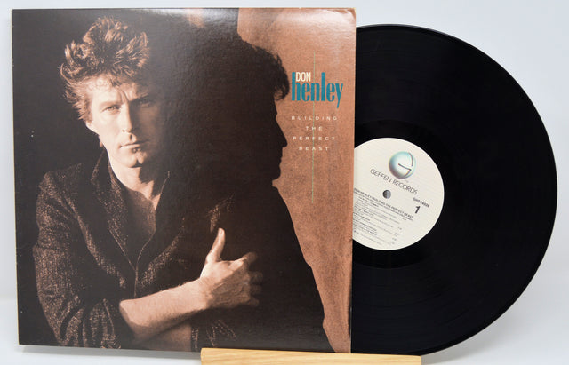 Vinyl record with cover featuring a person, on a white background
