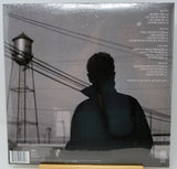 Back cover of a vinyl record sleeve for Timbaland's album 'This Is What I Want', showing a grayscale photo of a person from behind in front of a water tower, with tracklist text on the right.