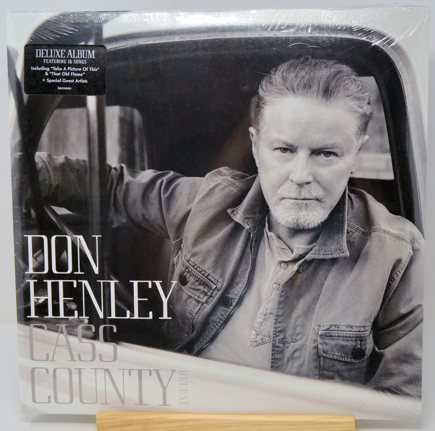 Don Henley 'Cass County' deluxe album vinyl record in its shrink wrap packaging, featuring a black and white portrait of the artist in a car.