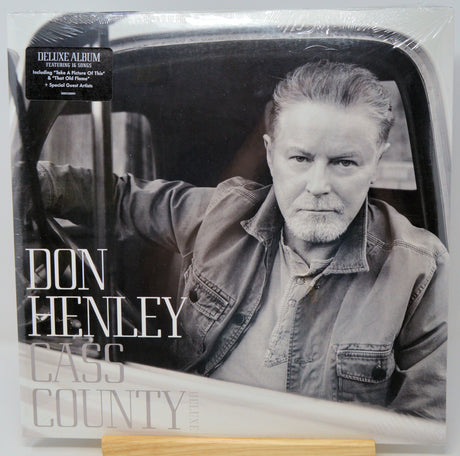 Don Henley 'Cass County' deluxe album vinyl record in its shrink wrap packaging, featuring a black and white portrait of the artist in a car.
