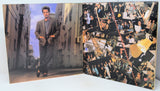 Album cover with a collage of a man and various images on the right side.