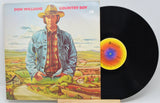 Front cover of Don Williams' Country Boy vinyl LP featuring illustrated portrait and scenic countryside