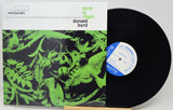 Donald Byrd's 'Byrd in Flight' vinyl record album, showing the front cover with a green and black bird illustration and the black LP record partially pulled out, revealing the blue and white record label.