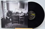 Donald Fagen's 'Morph the Cat' vinyl record LP, showing the black-and-white album cover sleeve on the left and the black vinyl record partially pulled out on the right, resting on a light wood stand against a white background.