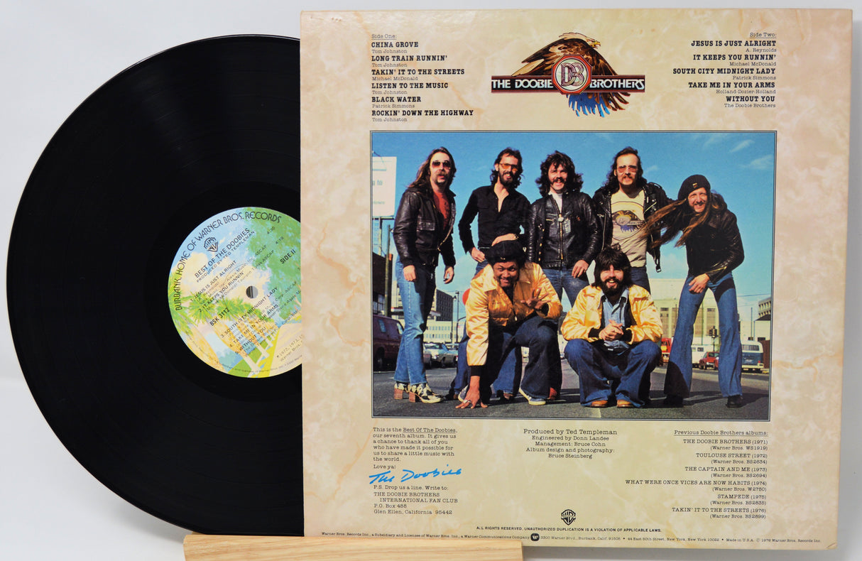 Vinyl record with cover featuring a group photo and text
