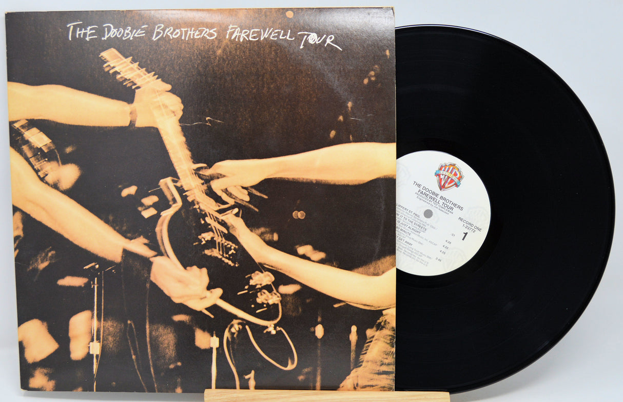 Vinyl record with cover showing a guitar and hands, titled 'The Double Brothers Farewell Tour'.