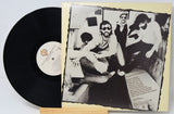 Vinyl record with a black and white photo of people on the cover