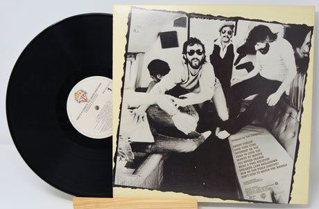 Vinyl record with a black and white photo of people on the cover
