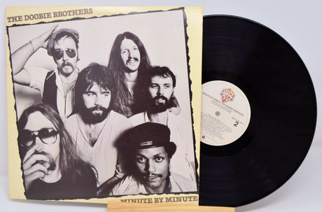 Vinyl record with cover featuring The Doobie Brothers on a light gray background