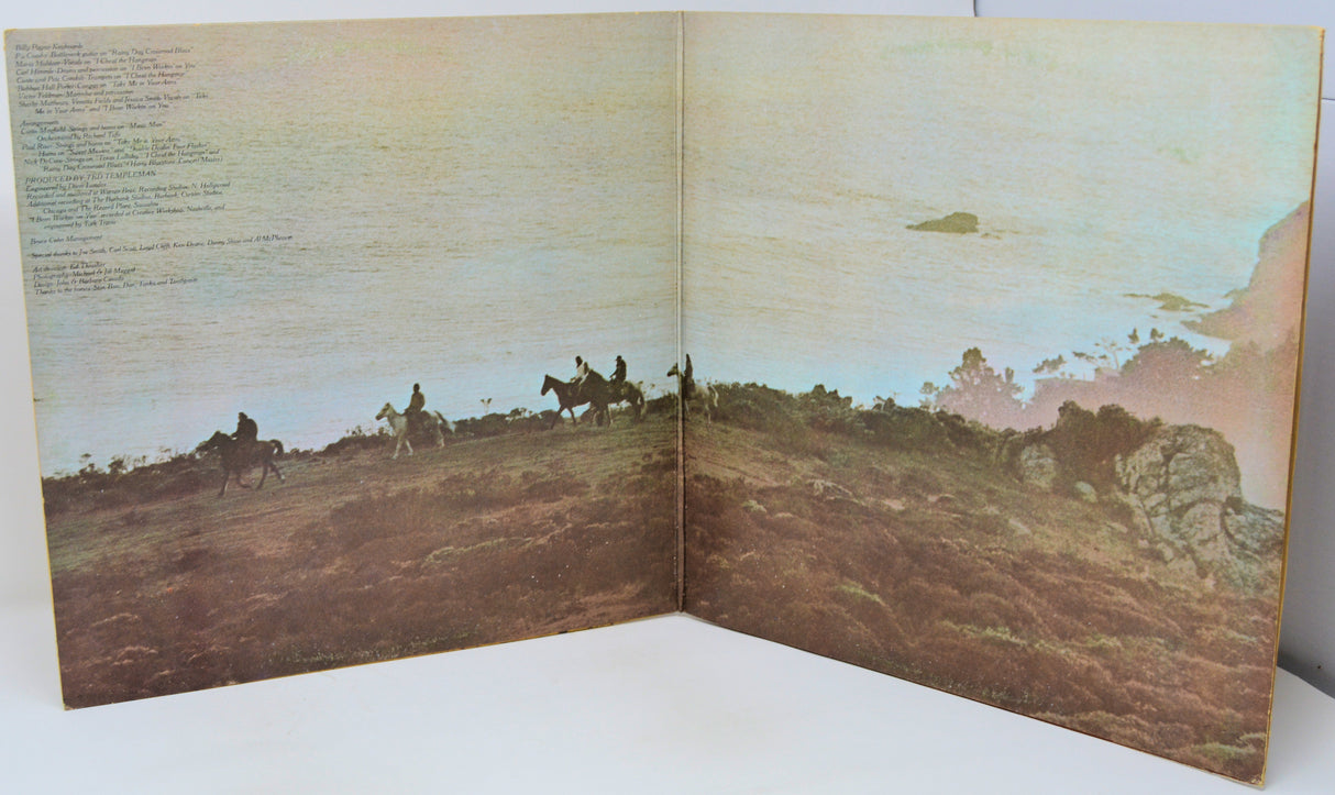 Open book with a landscape illustration of people on horseback and text on a white background