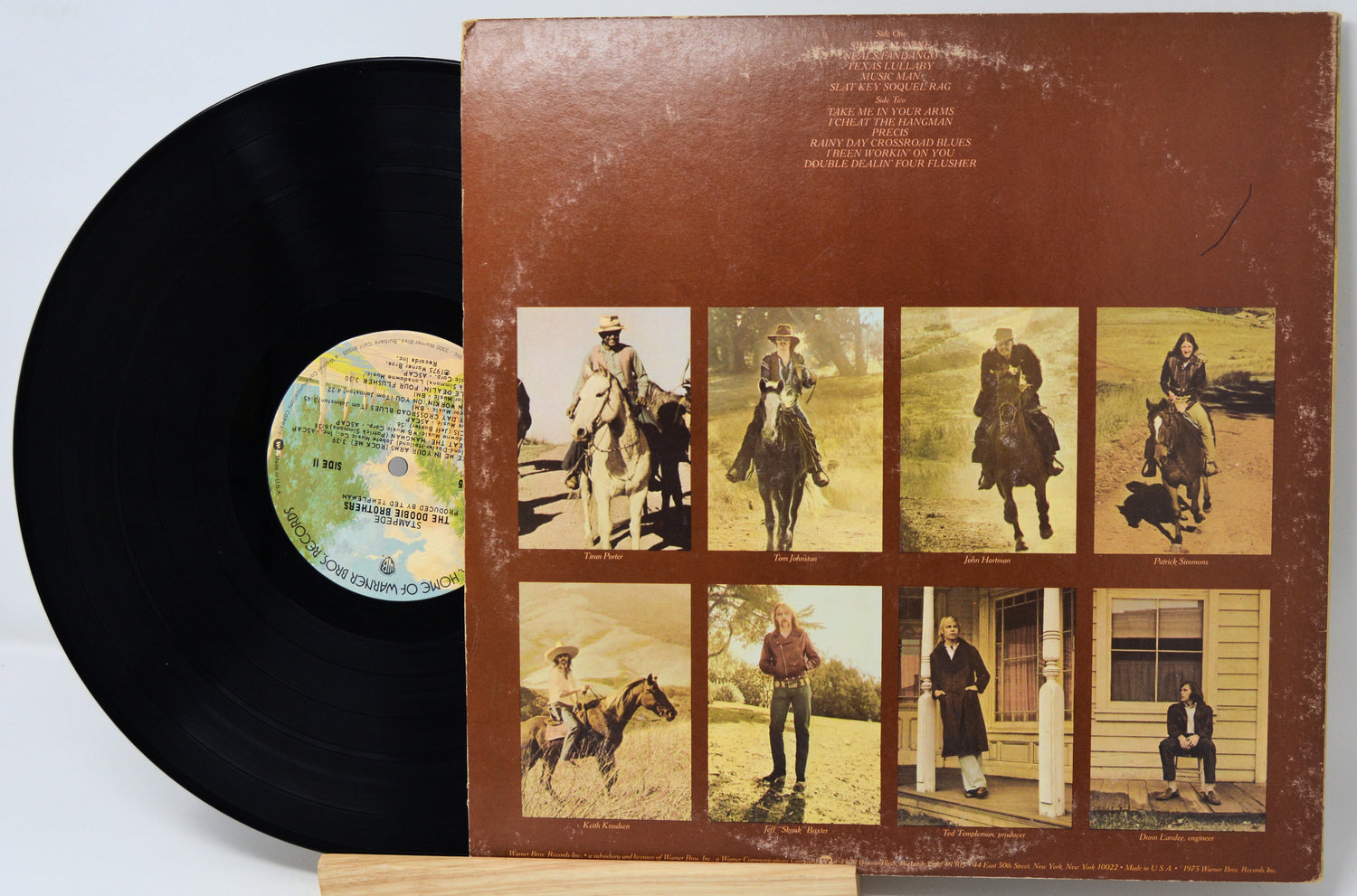Vinyl record with a brown cover featuring images of people on horses and a dog.