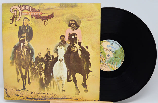 Vinyl record with a yellow cover featuring people on horseback, including a prominent image of a woman in a pink dress.