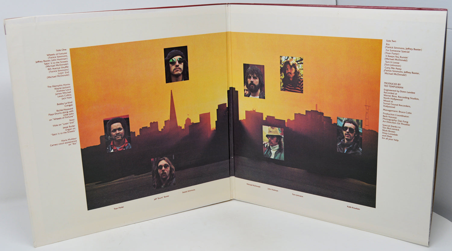 Album cover with a cityscape and portrait layout on an orange background