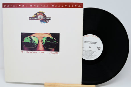 Vinyl record and cover with 'The Doobie Brothers' album on a white background