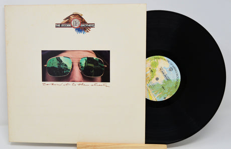 Vinyl record with cover featuring a person wearing sunglasses and a logo at the top.