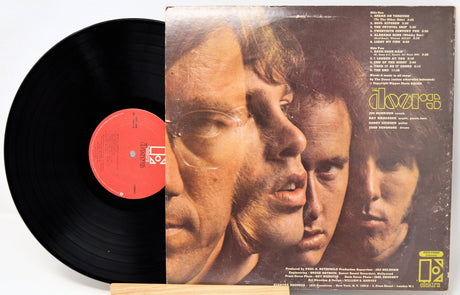 Vinyl record with a cover featuring three faces and text