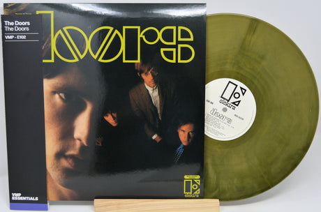 The Doors 'Light' vinyl record LP with its album cover sleeve and a translucent olive-green vinyl disc displayed on a small wooden stand.