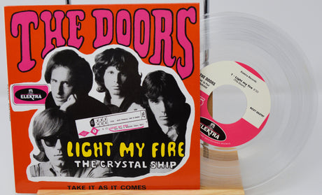 The Doors 'Light My Fire' vinyl record album with the orange cover jacket, a clear translucent record, and a pink-and-white center label on a light background.