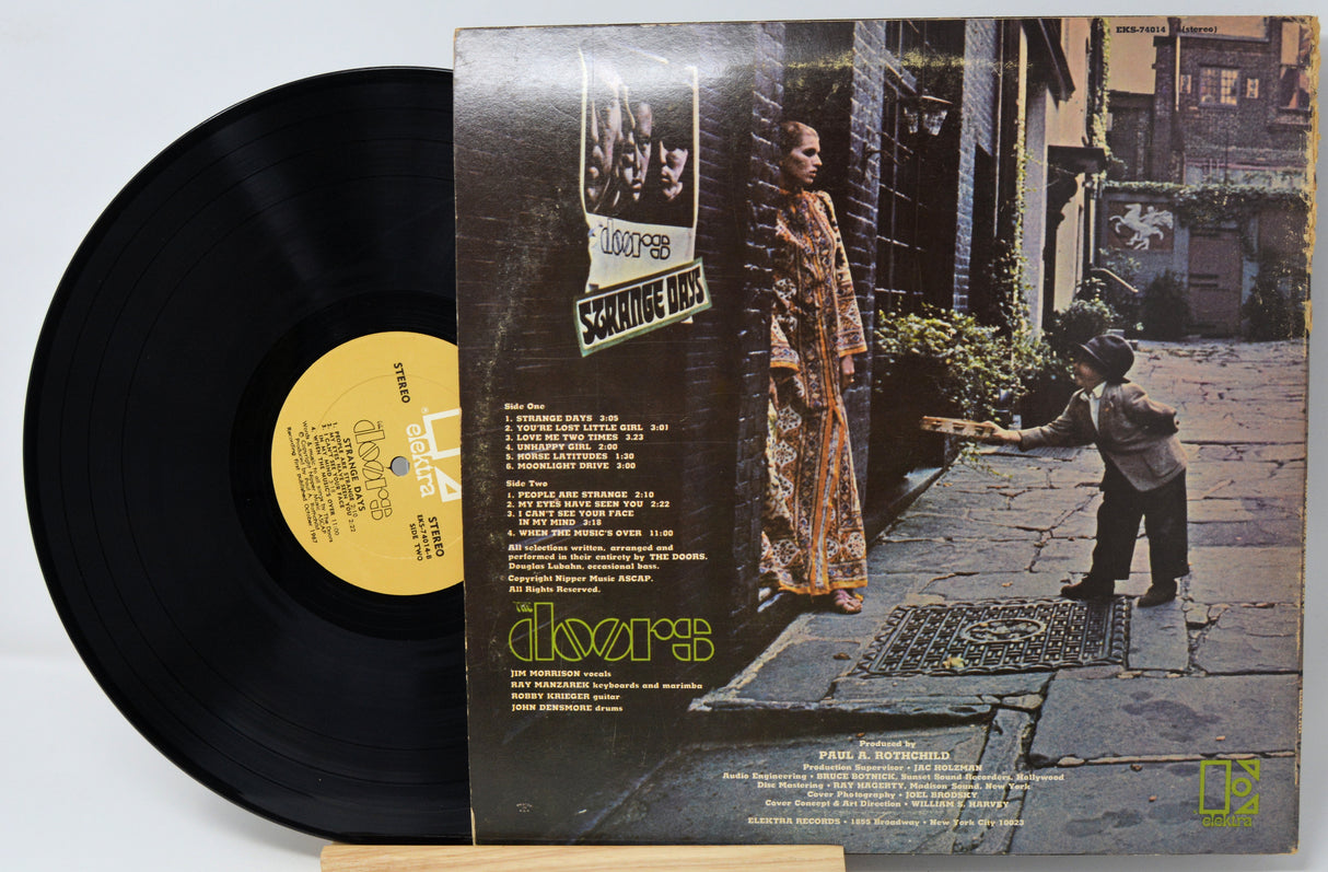 Vinyl record with cover featuring a woman and child on a stone path.