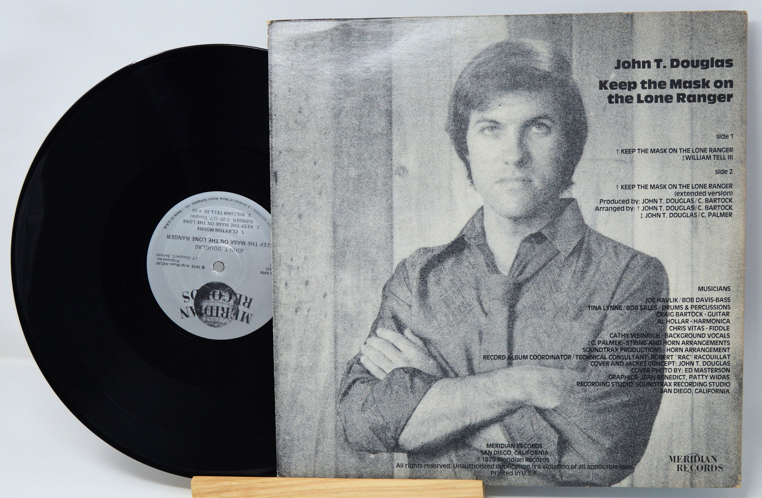 Vinyl record with cover featuring a person and text on a light gray background