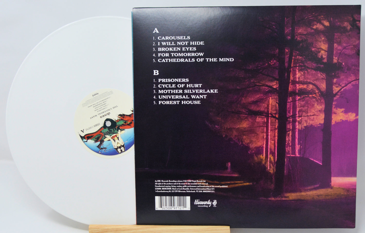 Vinyl record with a cover featuring a forest scene and tracklist.