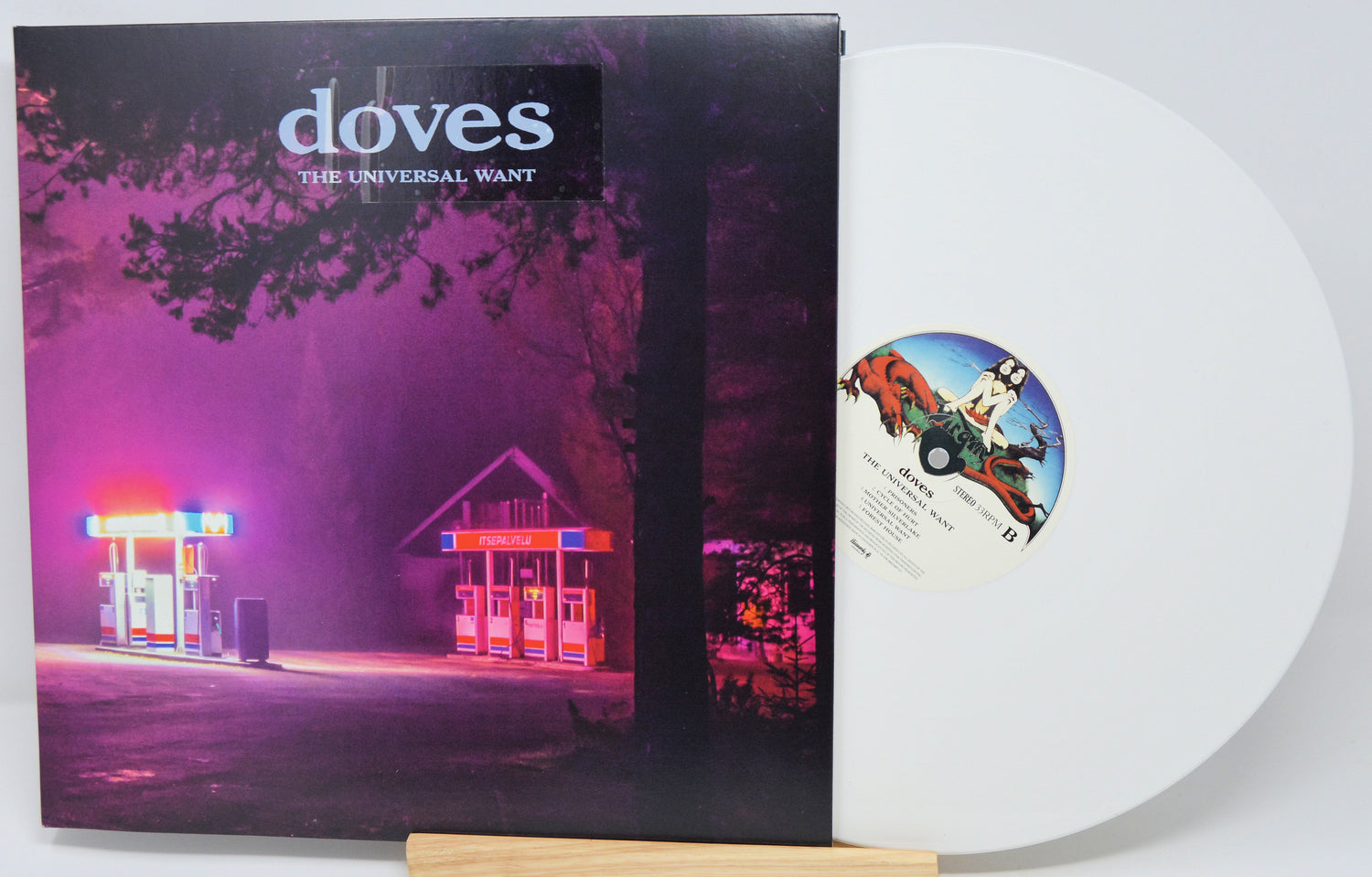 Vinyl record with cover featuring a gas station at night and 'doves' album text.