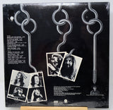 Vinyl record sleeve with black and white photos and text on a dark background