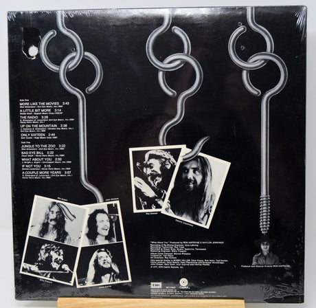 Vinyl record sleeve with black and white photos and text on a dark background