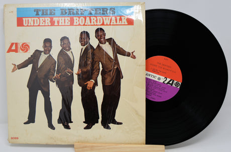 Vinyl record with cover featuring four men and 'The Drifters Under The Boardwalk' text.